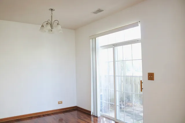 a view of a room with wooden floor and windows