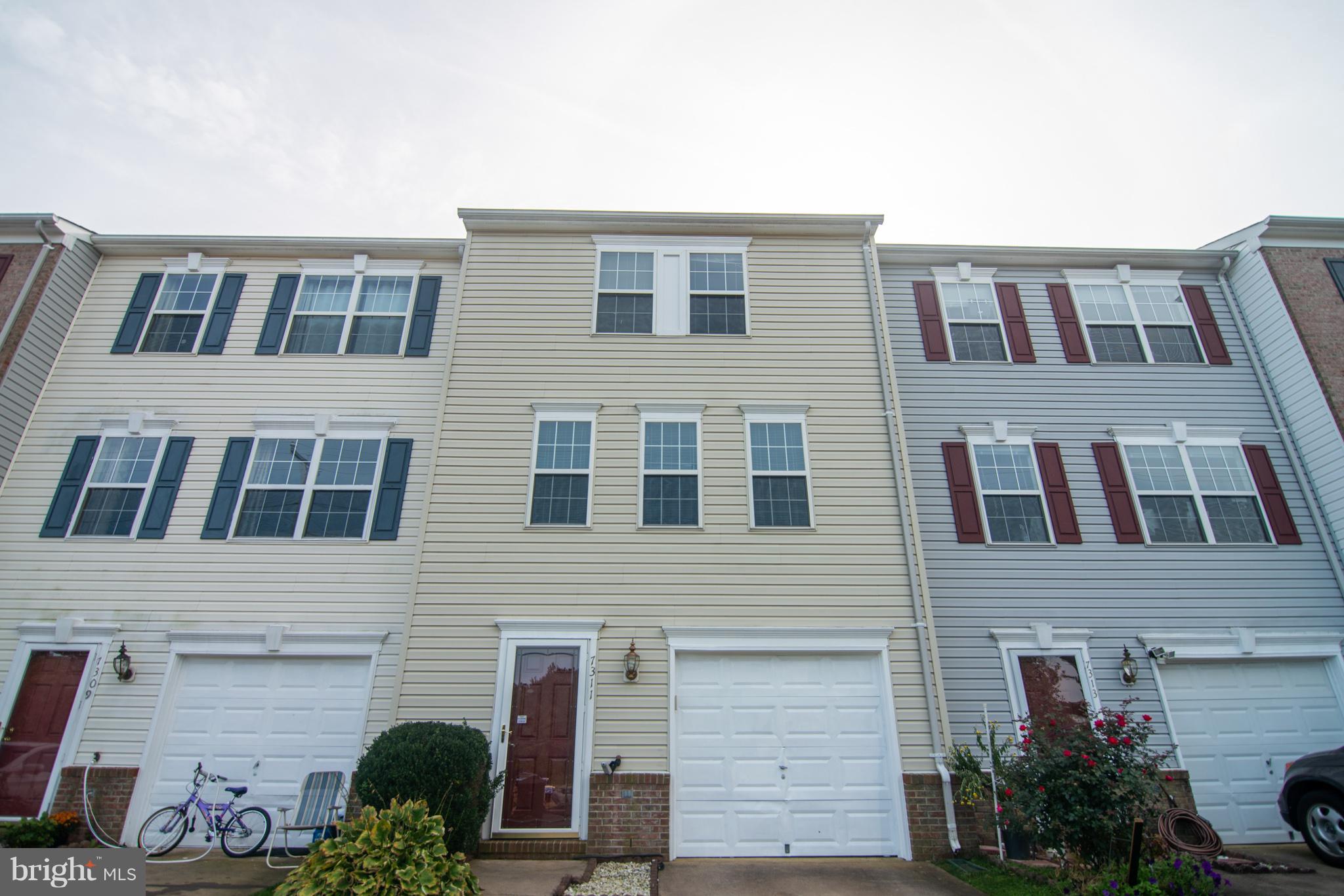 7311 Gateside Place Springfield, VA 22150 - Photo 1 of 30 a front view of a building with potted plants