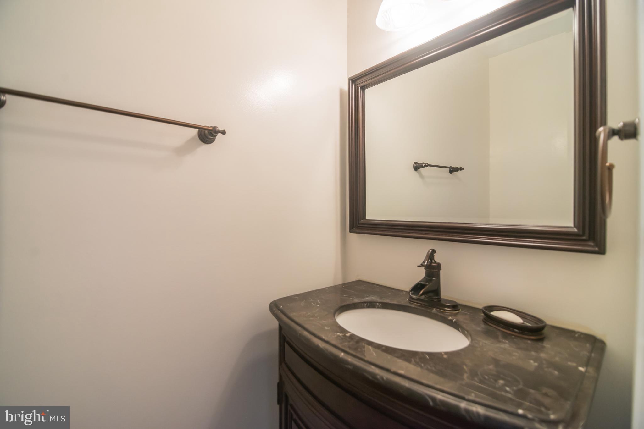 7311 Gateside Place Springfield, VA 22150 - Photo 11 of 30 a bathroom with a granite countertop sink and a mirror