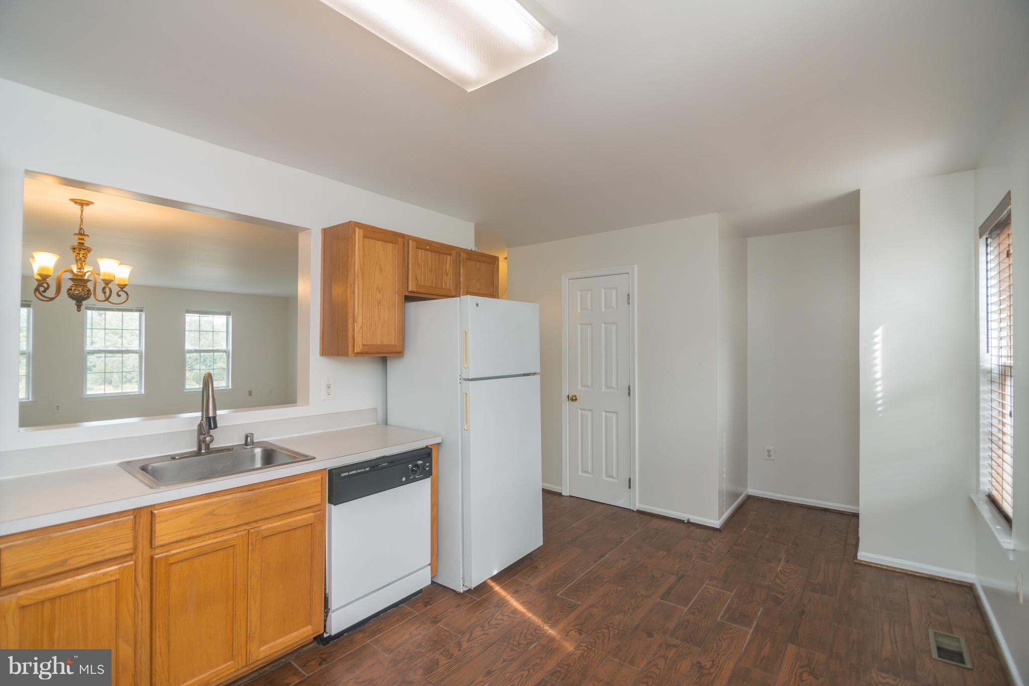 7311 Gateside Place Springfield, VA 22150 - Photo 13 of 30 a kitchen with a sink cabinets stainless steel appliances and a window