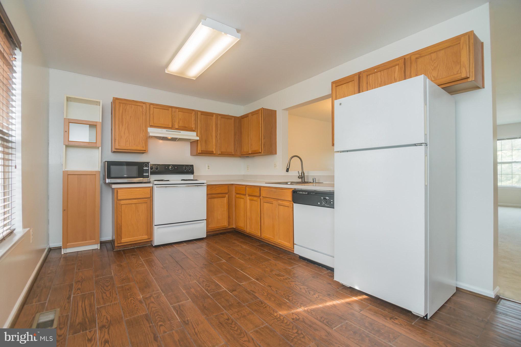 7311 Gateside Place Springfield, VA 22150 - Photo 14 of 30 a kitchen with a white cabinets and white appliances