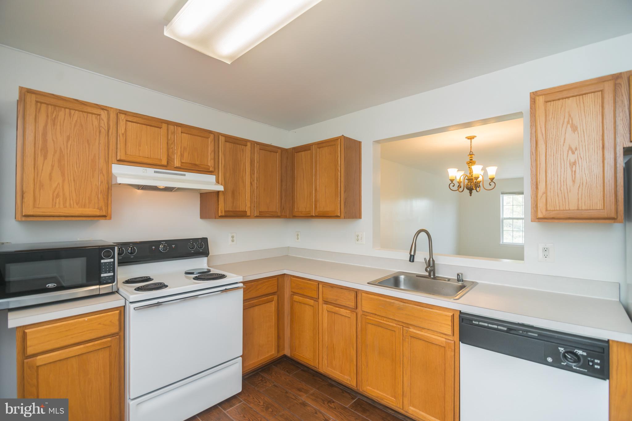 7311 Gateside Place Springfield, VA 22150 - Photo 15 of 30 a kitchen with stainless steel appliances granite countertop a sink stove and cabinets