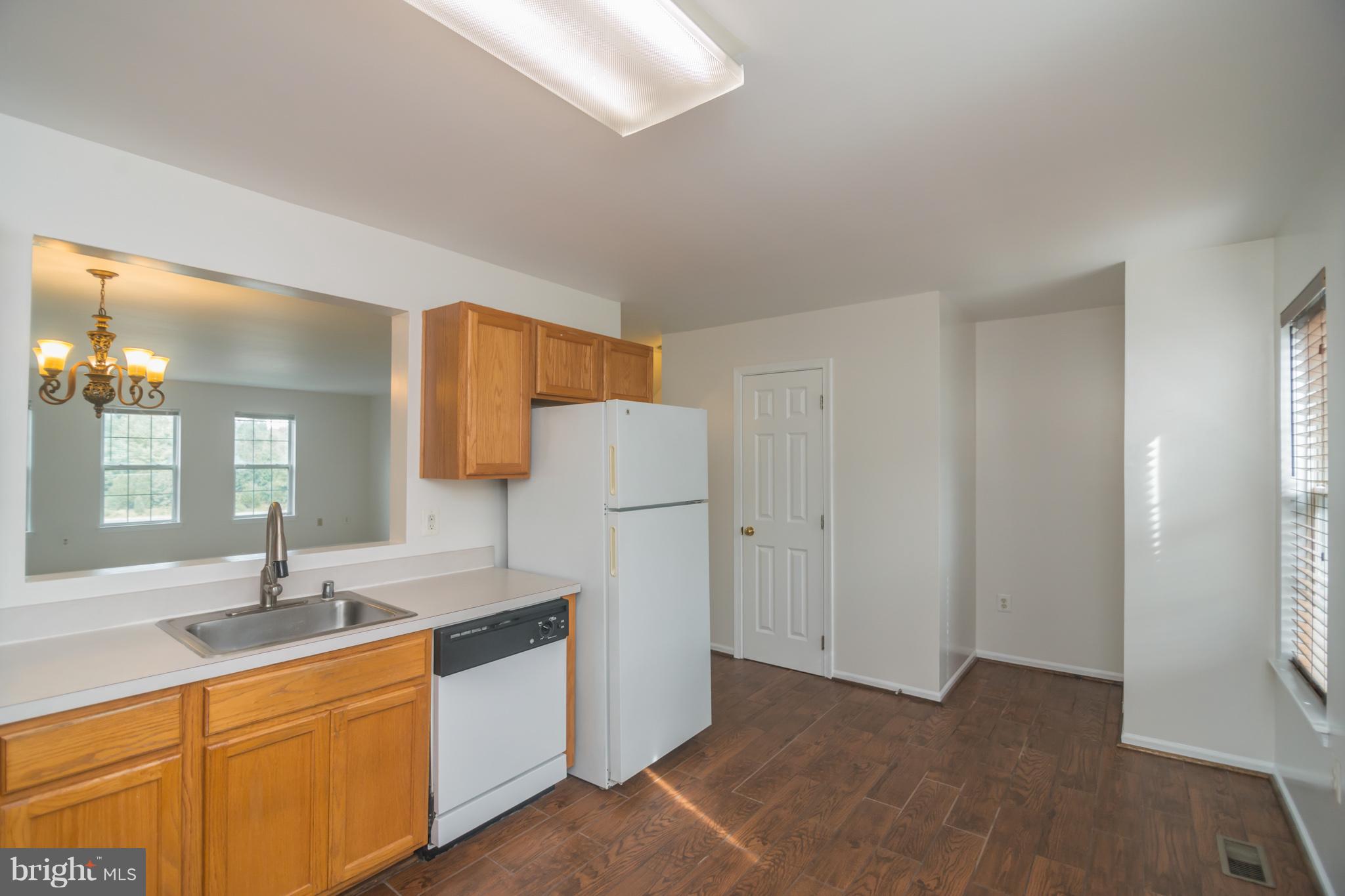 7311 Gateside Place Springfield, VA 22150 - Photo 16 of 30 a kitchen with stainless steel appliances granite countertop a sink and a granite counter tops