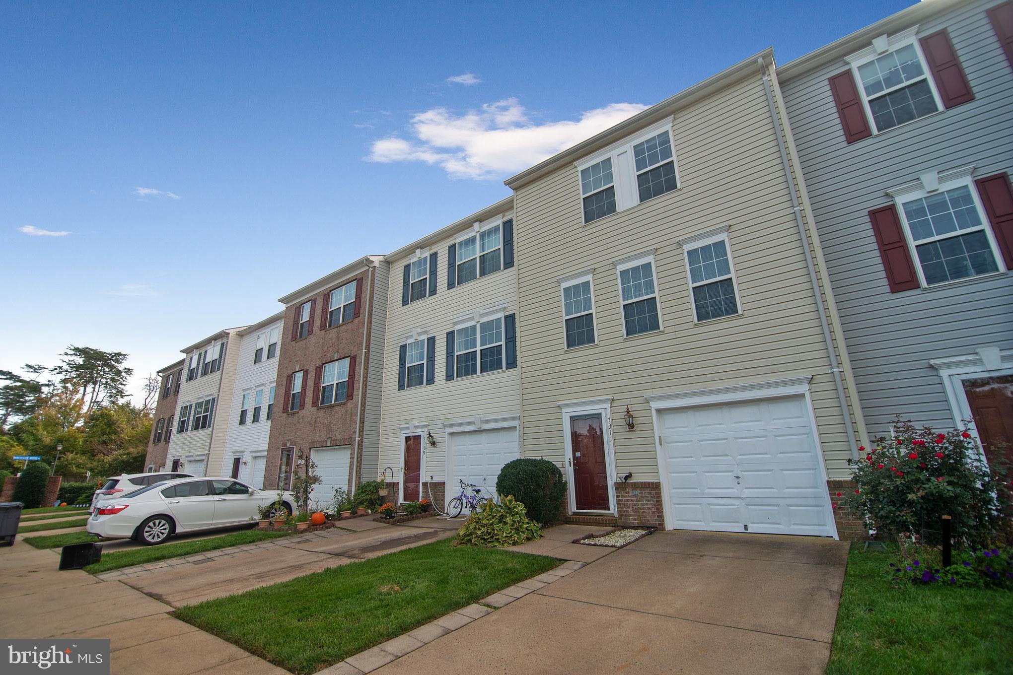 7311 Gateside Place Springfield, VA 22150 - Photo 3 of 30 a front view of a building with cars parked