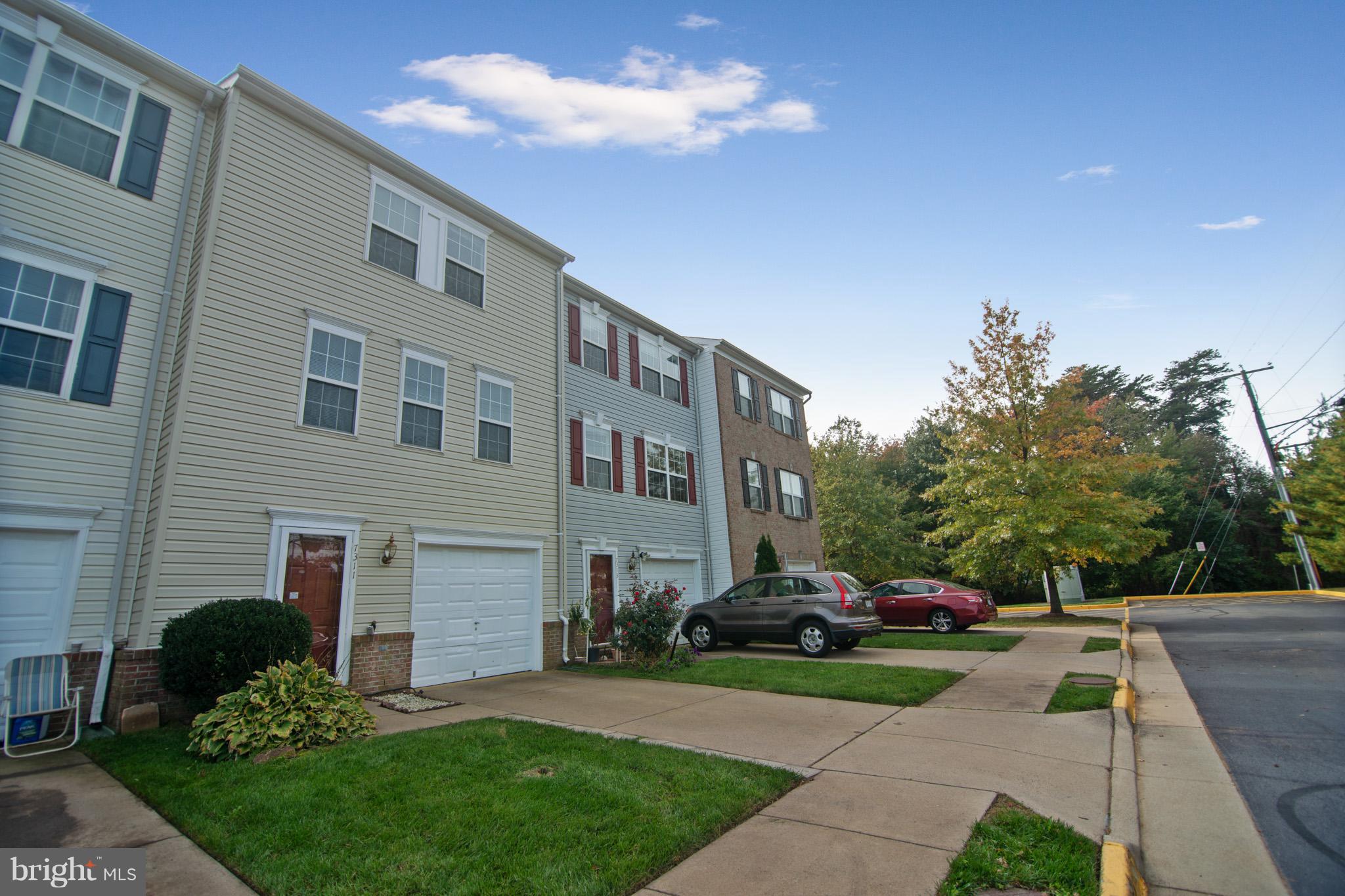 7311 Gateside Place Springfield, VA 22150 - Photo 4 of 30 a front view of a house with a garden and plants