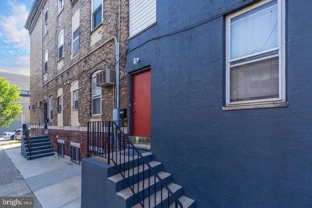 a view of a brick building with many windows