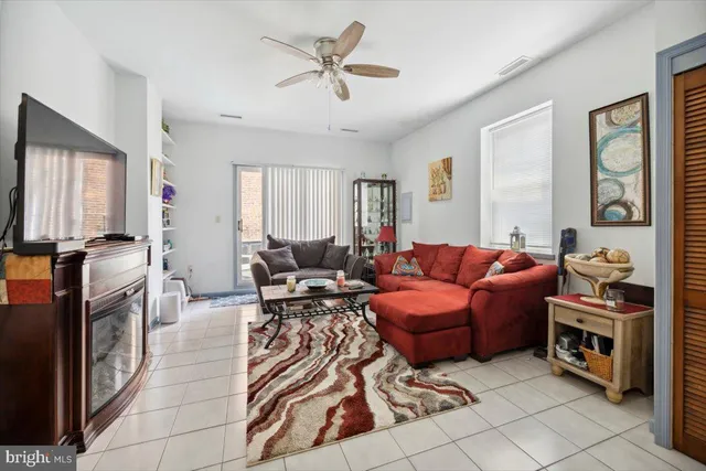 a living room with furniture fireplace and a window