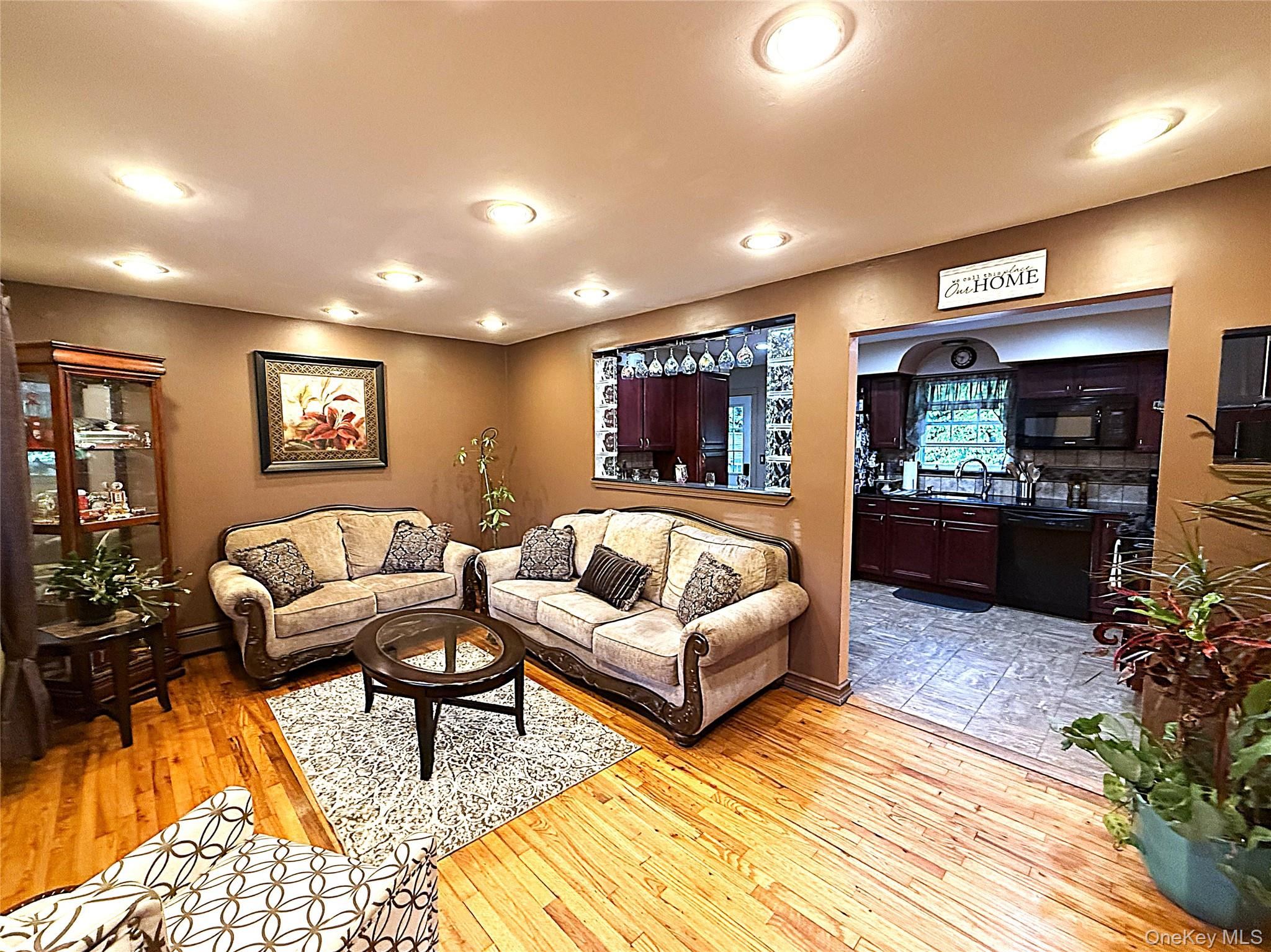 1 Heston Road Shirley, NY 11967 - Photo 8 of 32 Living area featuring wood-finish flooring, recessed lighting, and a pass-through window to the kitchen