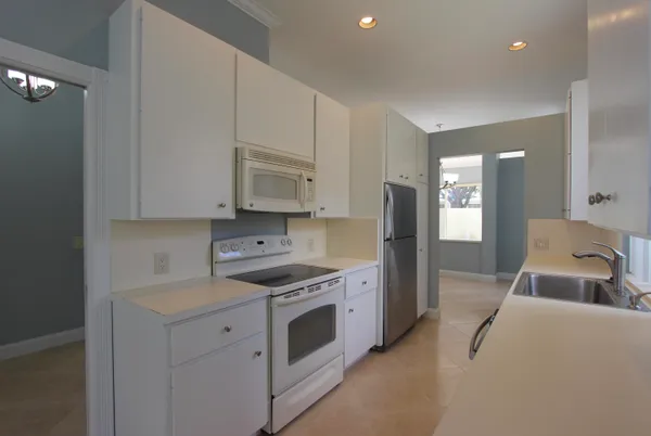 a kitchen with stainless steel appliances white cabinets and a sink