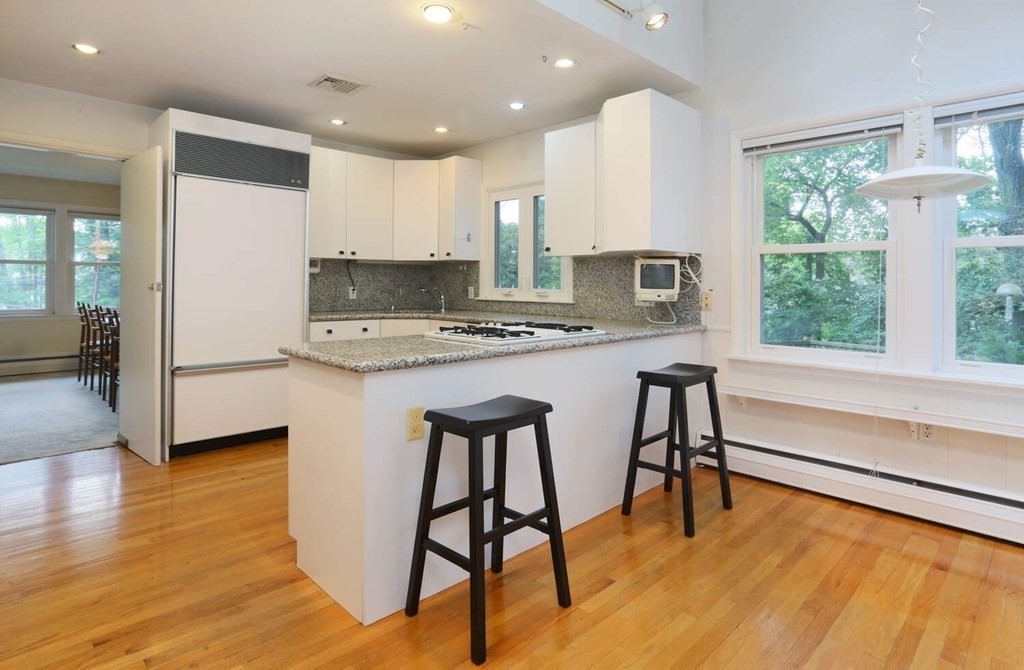 150 Buckminster Road Brookline, MA 02445 - Photo 23 of 25 a kitchen with stainless steel appliances granite countertop a stove a sink and a refrigerator