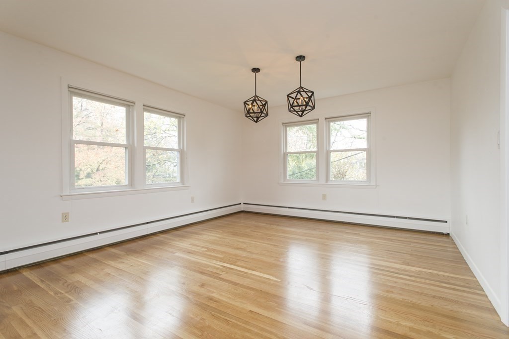 150 Buckminster Road Brookline, MA 02445 - Photo 8 of 25 wooden floor in an empty room with a window