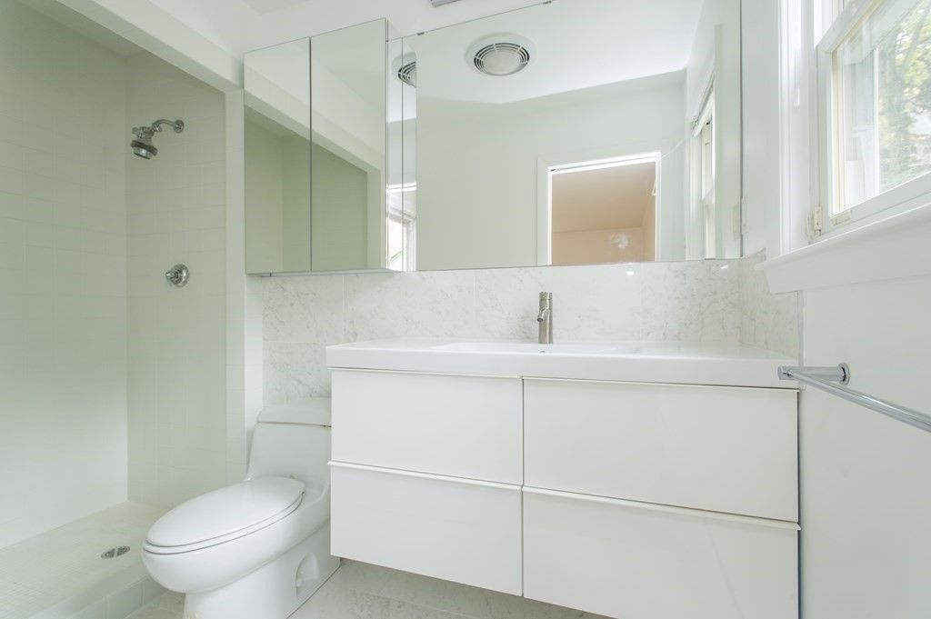 150 Buckminster Road Brookline, MA 02445 - Photo 9 of 25 a bathroom with a sink a toilet and shower