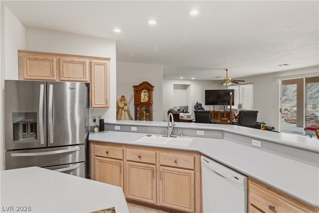3589 Cottage Canyon Street Laughlin, NV 89029 - Photo 17 of 99 Kitchen featuring light wood finish cabinetry, stainless steel fridge with ice dispenser, light countertops, white dishwasher, and a ceiling fan