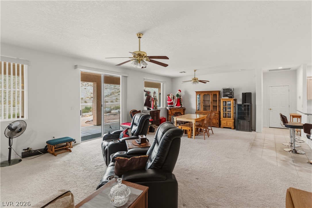3589 Cottage Canyon Street Laughlin, NV 89029 - Photo 22 of 99 Living room with light carpet, ceiling fan, and a textured ceiling