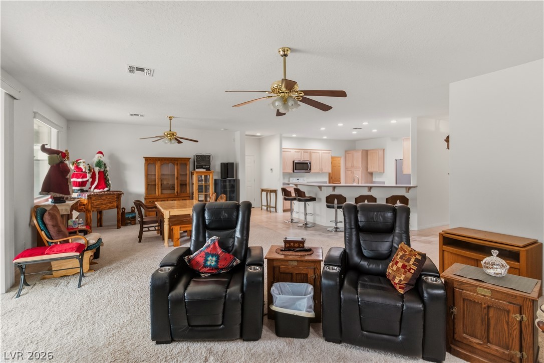 3589 Cottage Canyon Street Laughlin, NV 89029 - Photo 23 of 99 Living area with ceiling fan and light carpet