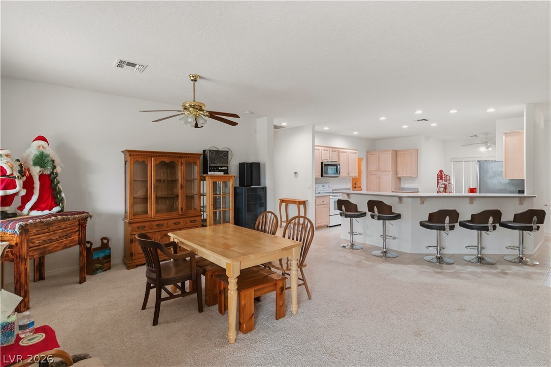 3589 Cottage Canyon Street Laughlin, NV 89029 - Photo 24 of 99 Dining room with ceiling fan, light carpet, and recessed lighting