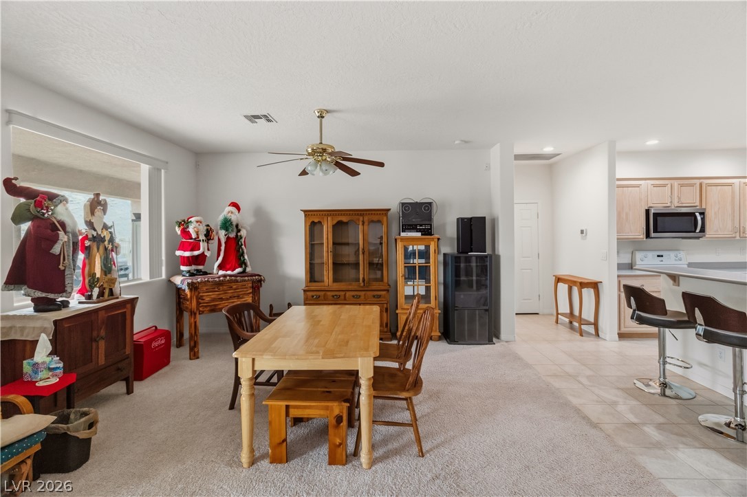 3589 Cottage Canyon Street Laughlin, NV 89029 - Photo 25 of 99 Dining space with light carpet and a ceiling fan