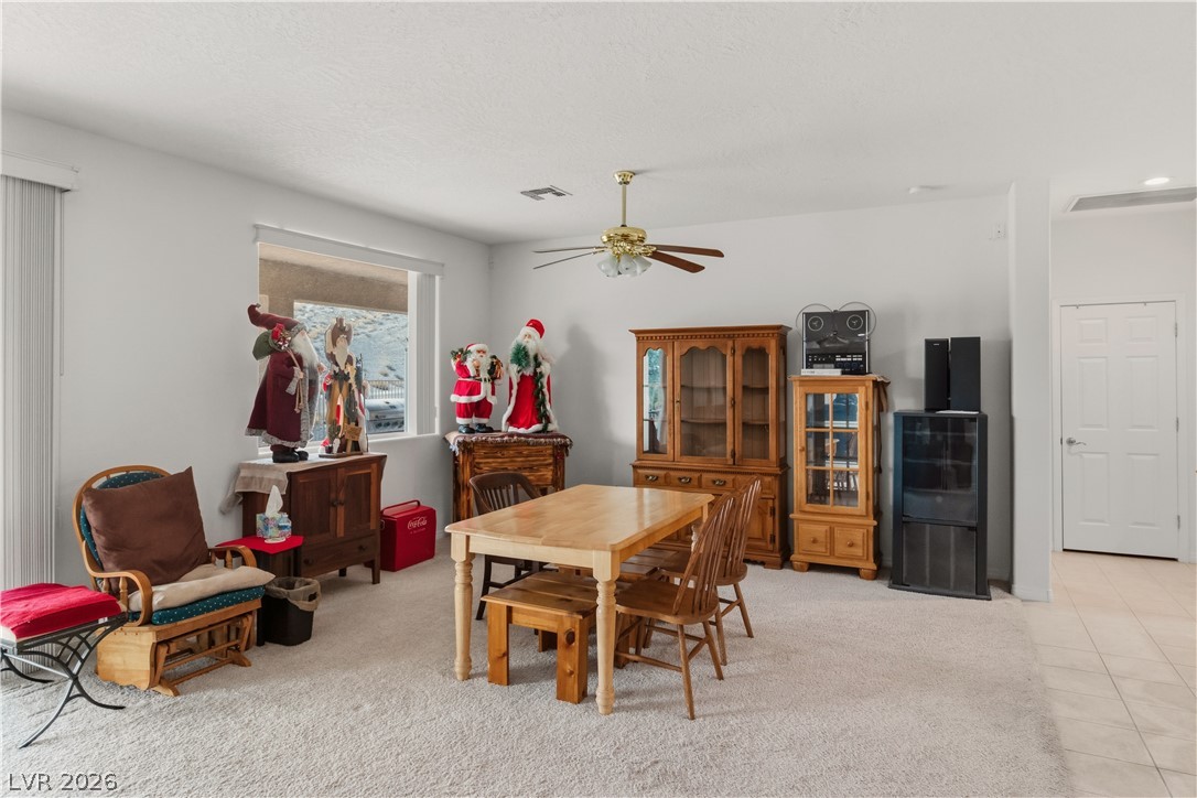 3589 Cottage Canyon Street Laughlin, NV 89029 - Photo 26 of 99 Dining area featuring ceiling fan and light colored carpet