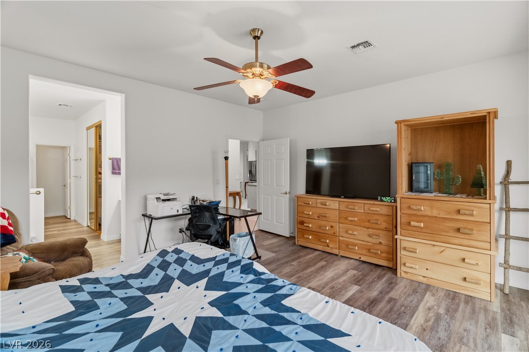 3589 Cottage Canyon Street Laughlin, NV 89029 - Photo 30 of 99 Primary Bedroom with light wood-style flooring and a ceiling fan