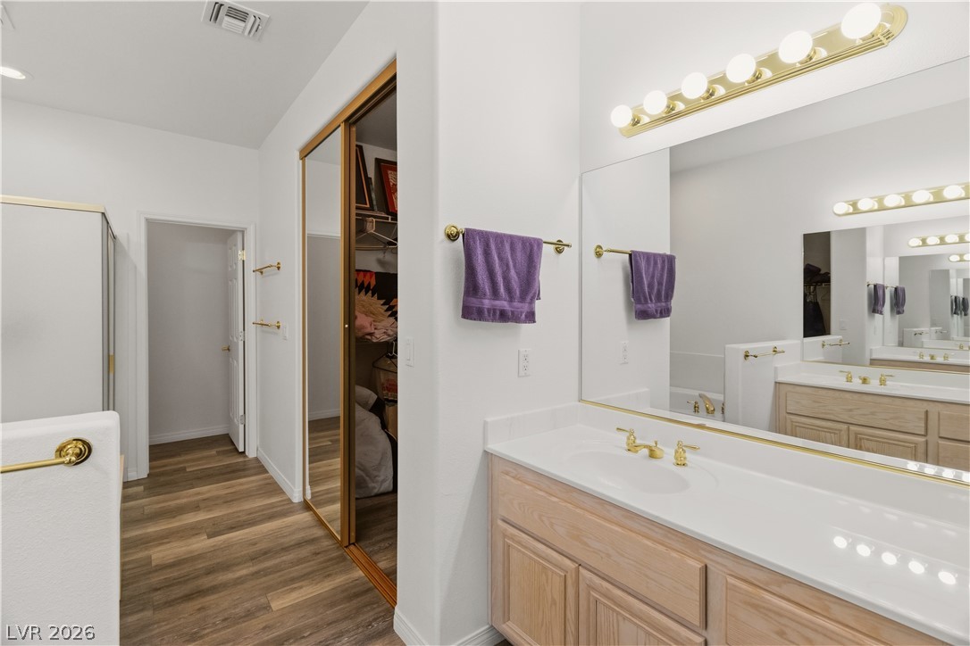 3589 Cottage Canyon Street Laughlin, NV 89029 - Photo 32 of 99 Full Primary bathroom with vanity, a spacious closet, and dark wood-style flooring