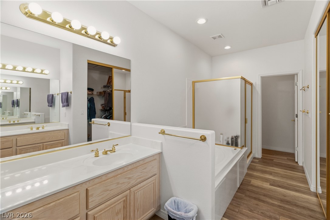 3589 Cottage Canyon Street Laughlin, NV 89029 - Photo 33 of 99 Primary Bathroom featuring vanity, a shower stall, a bath, recessed lighting, and a spacious closet