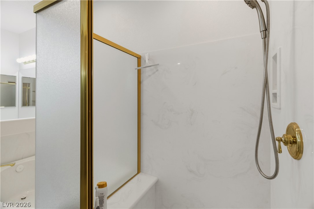 3589 Cottage Canyon Street Laughlin, NV 89029 - Photo 35 of 99 Primary Bathroom featuring a marble finish shower and a bath