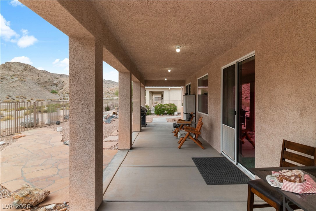 3589 Cottage Canyon Street Laughlin, NV 89029 - Photo 59 of 99 Fenced backyard with a mountain view and a patio