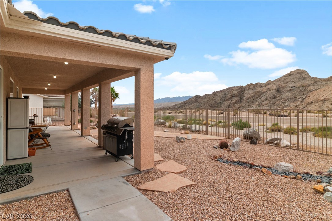 3589 Cottage Canyon Street Laughlin, NV 89029 - Photo 64 of 99 Fenced backyard with a grill and a mountain view