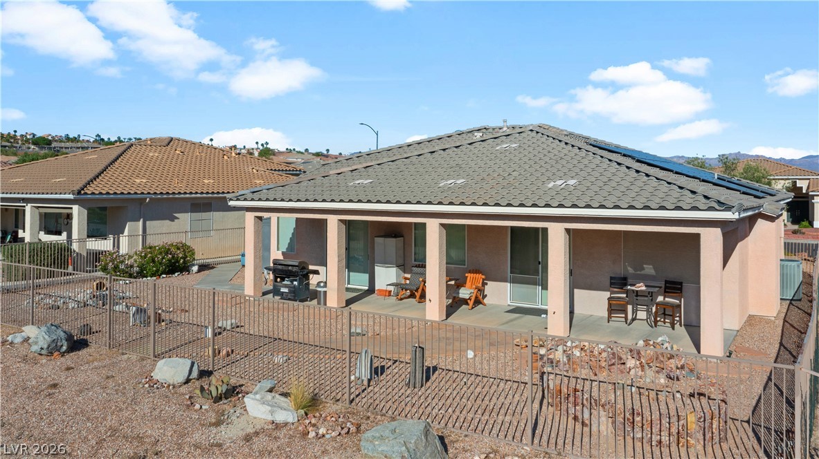3589 Cottage Canyon Street Laughlin, NV 89029 - Photo 87 of 99 Back of house featuring a fenced backyard, a patio area, stucco siding, and solar panels