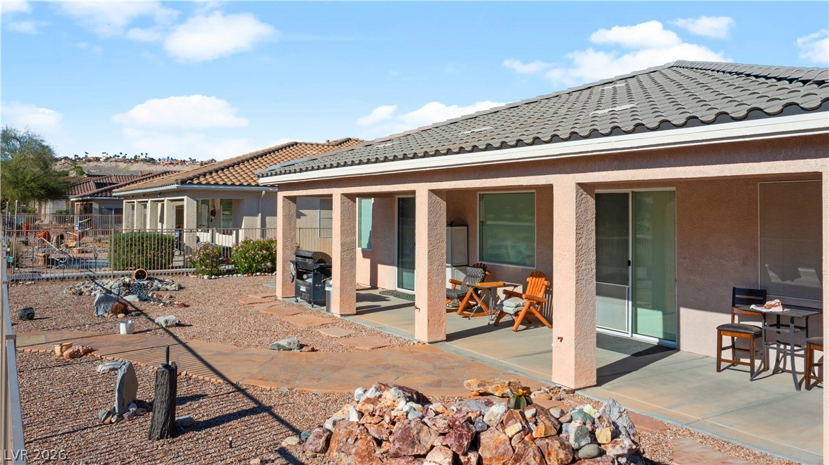 3589 Cottage Canyon Street Laughlin, NV 89029 - Photo 88 of 99 Rear view of house with a patio area, stucco siding, and a tile roof