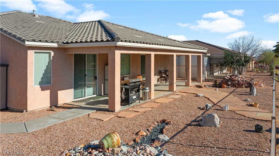 3589 Cottage Canyon Street Laughlin, NV 89029 - Photo 89 of 99 Rear view of property with stucco siding, a patio area, and a tiled roof