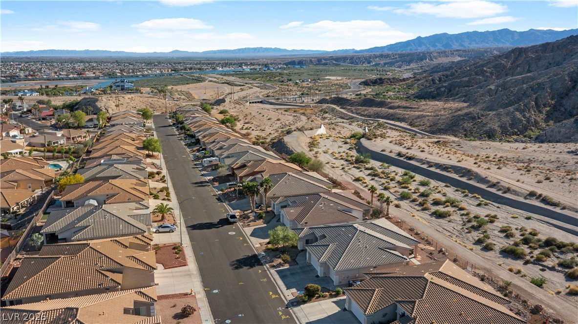 3589 Cottage Canyon Street Laughlin, NV 89029 - Photo 95 of 99 Aerial perspective of suburban area featuring mountains
