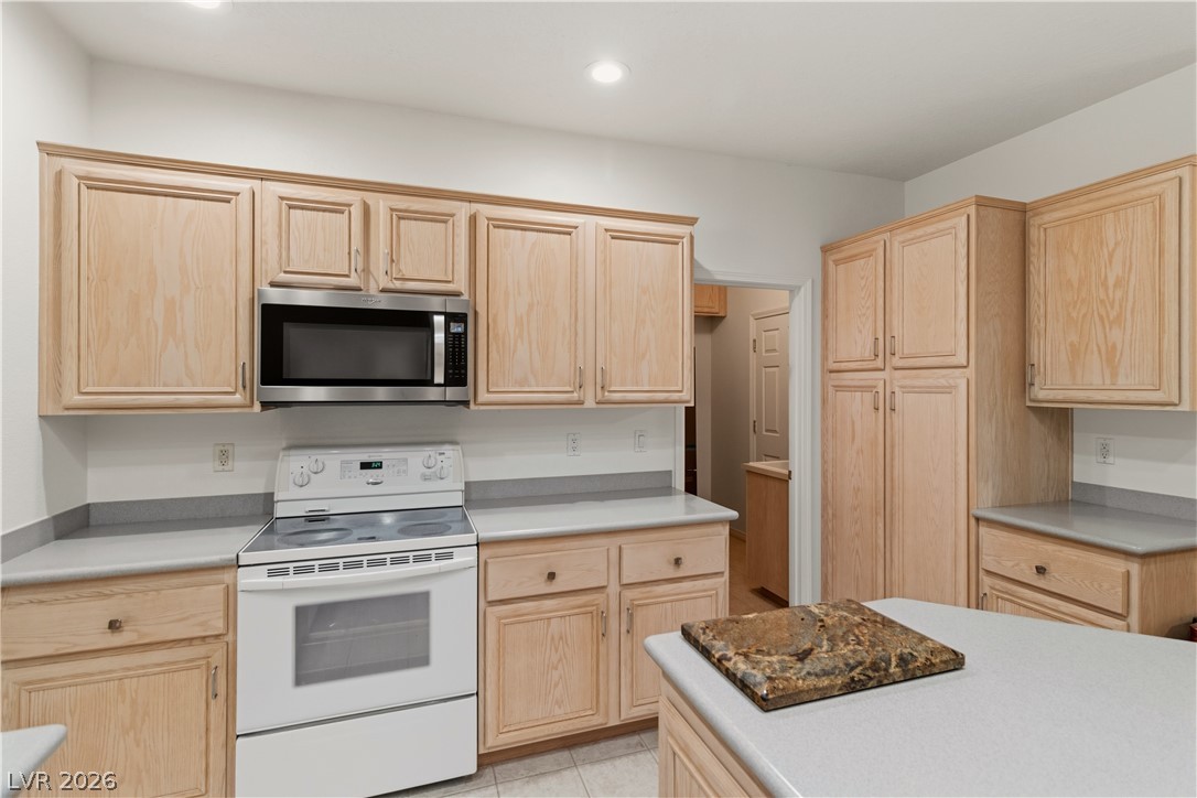 3589 Cottage Canyon Street Laughlin, NV 89029 - Photo 10 of 99 Kitchen with light wood finish cabinetry, electric stove, and recessed lighting