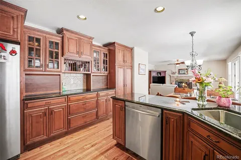 a kitchen with stainless steel appliances granite countertop a sink and wooden cabinets