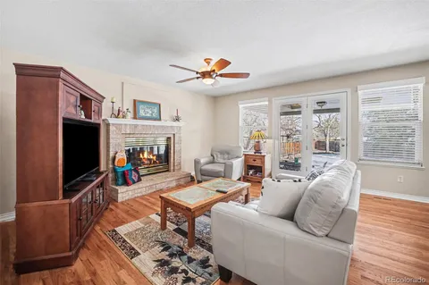 a living room with furniture a flat screen tv and a fireplace