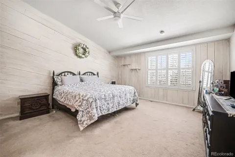 a bedroom with a bed a dresser next to a window