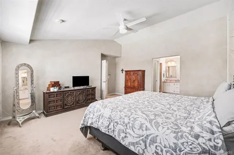 a bedroom with a bed and dresser with mirror