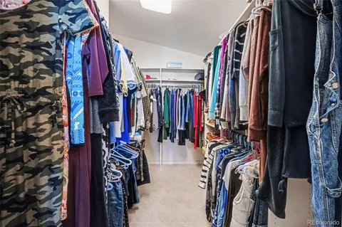 a view of walk in closet with clothes