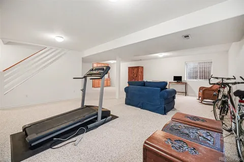 a living room with furniture flat screen tv and a table