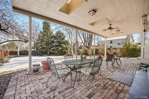a view of a patio with a dining table and chairs