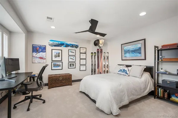a bedroom with a bed a desk and chair