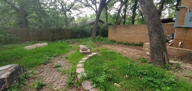 a view of a backyard with large tree
