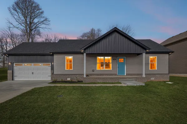 a front view of a house with a yard