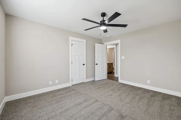 a view of a big room with a ceiling fan and a ceiling fan