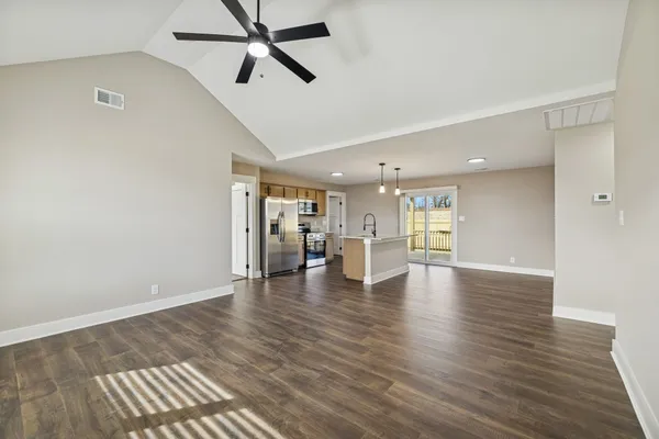 a view of empty room with wooden floor