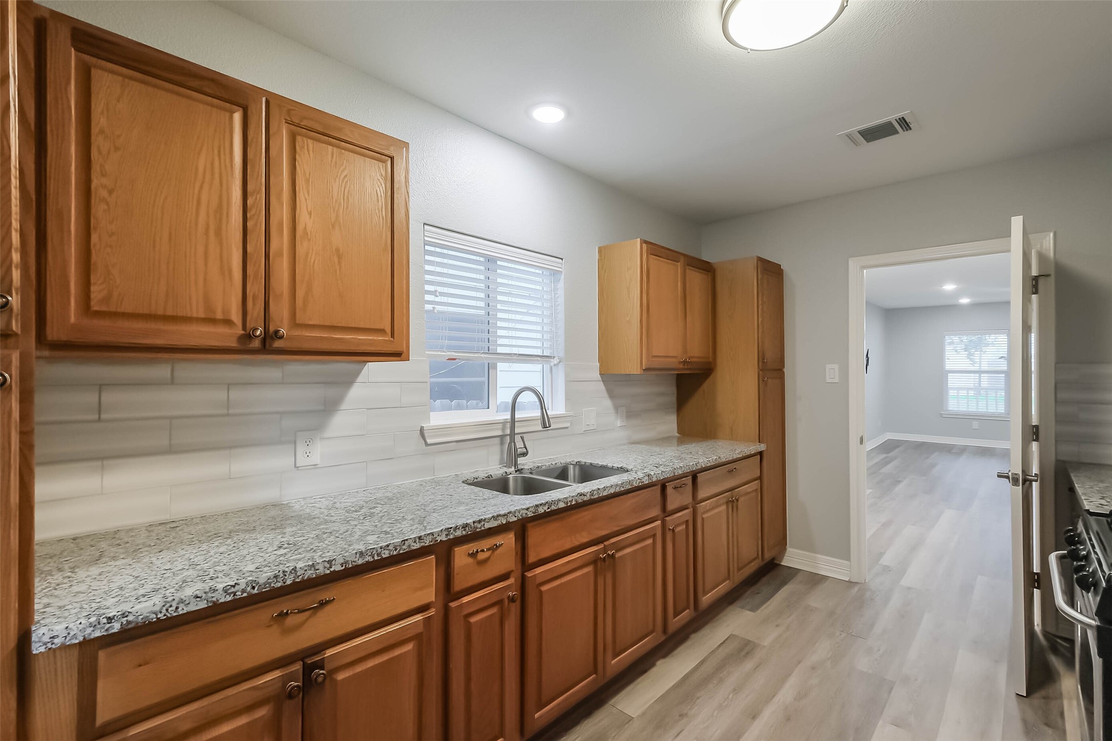 809 Vincent Street Houston, TX 77009 - Photo 8 of 37 Renovated kitchen includes granite countertops and maple cabinets.