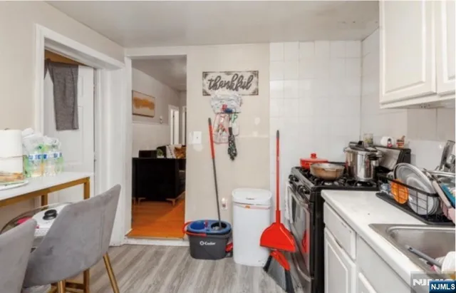 a view of a kitchen filled with furniture and a sink