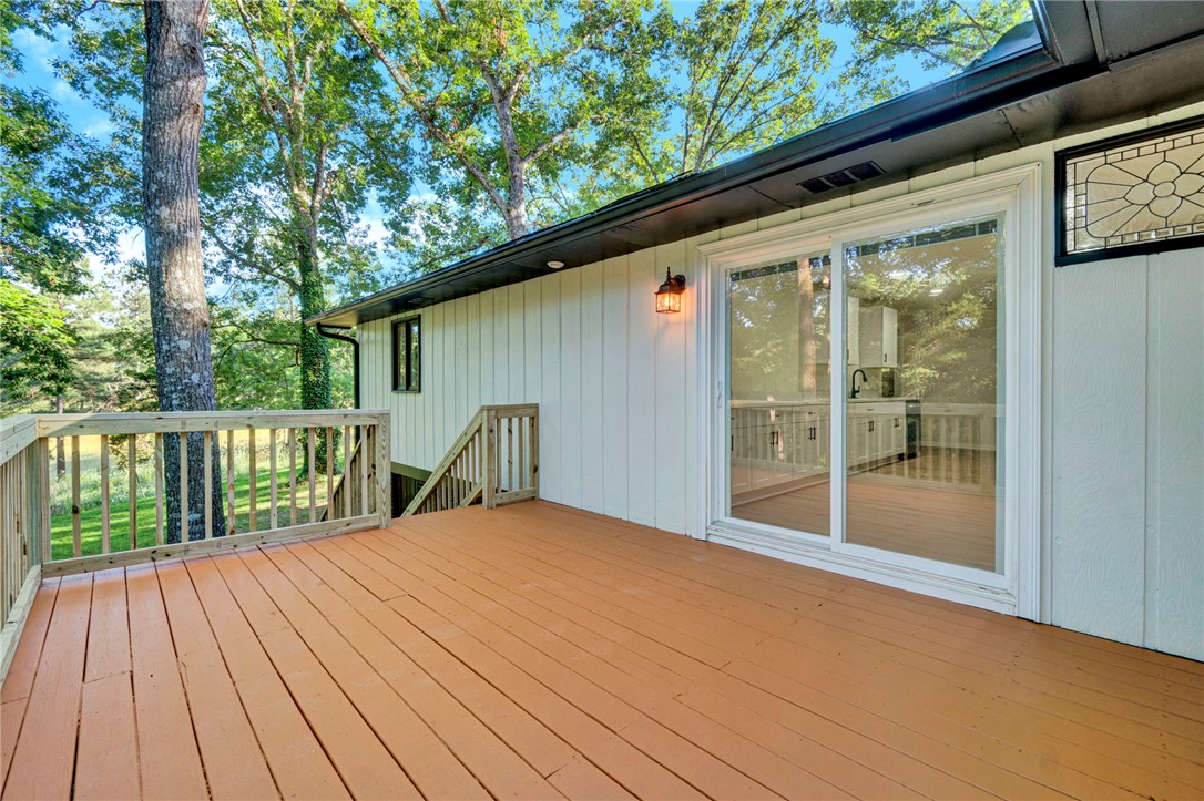 237 Earle Road Central, SC 29630 - Photo 21 of 24 A spacious wooden deck provides ample outdoor living space, perfect for entertaining or quiet enjoyment amidst nature.