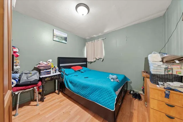 a bedroom with a bed and a dresser