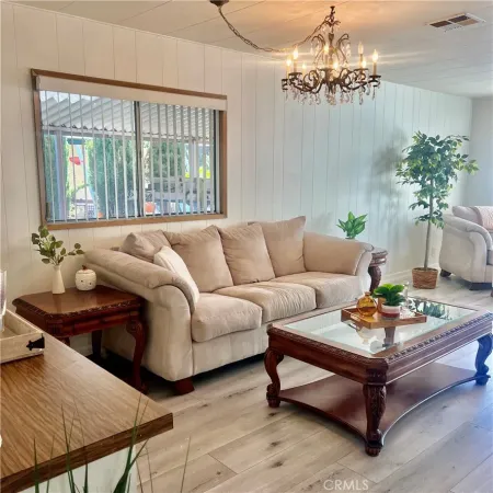a living room with furniture and a chandelier